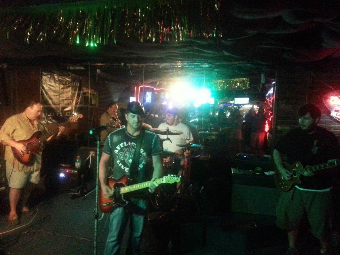 Band performing live under neon green stage lighting