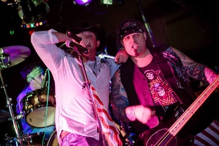 Marc Kenney and band performing live under purple stage lighting